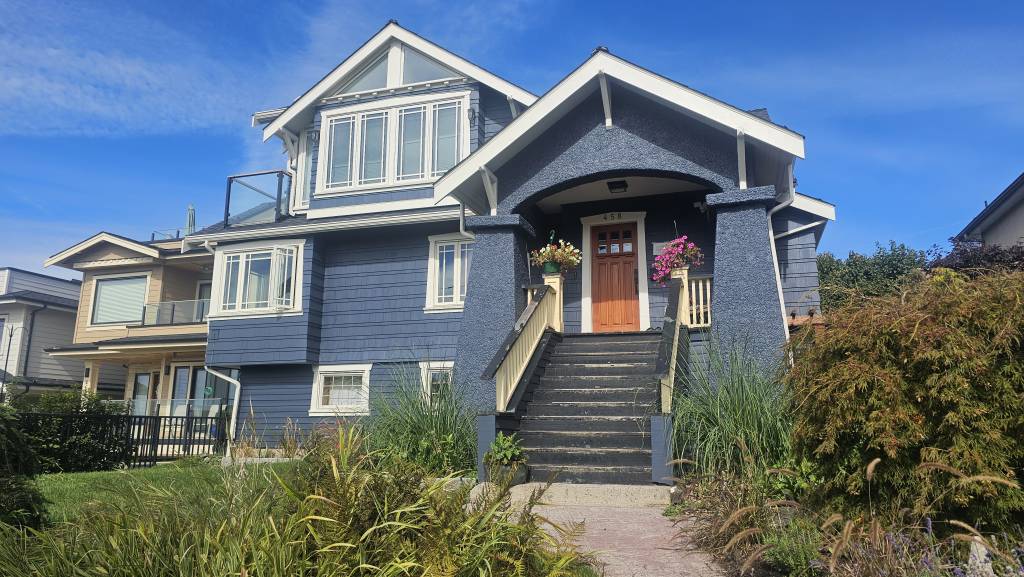 Blue heritage-style home exterior with painted siding and trim